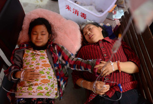 Injured people receive treatment at temporary medical tents in Baosheng